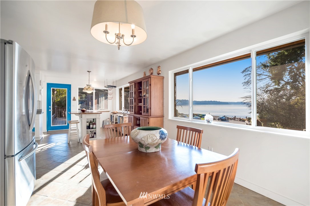 731 Woodmont Beach Road South Des Moines, WA 98198 - Photo 13 of 40 a dining room with furniture a large window and plants