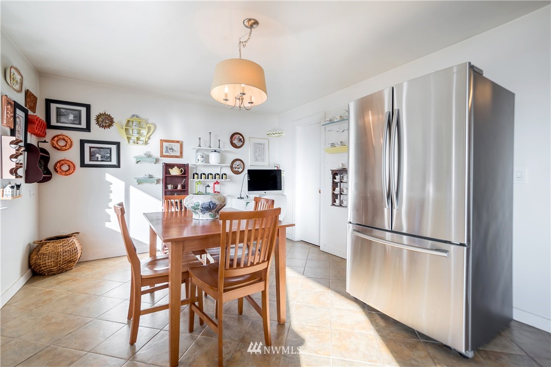 731 Woodmont Beach Road South Des Moines, WA 98198 - Photo 14 of 40 a view of a dining room with furniture window and wooden floor