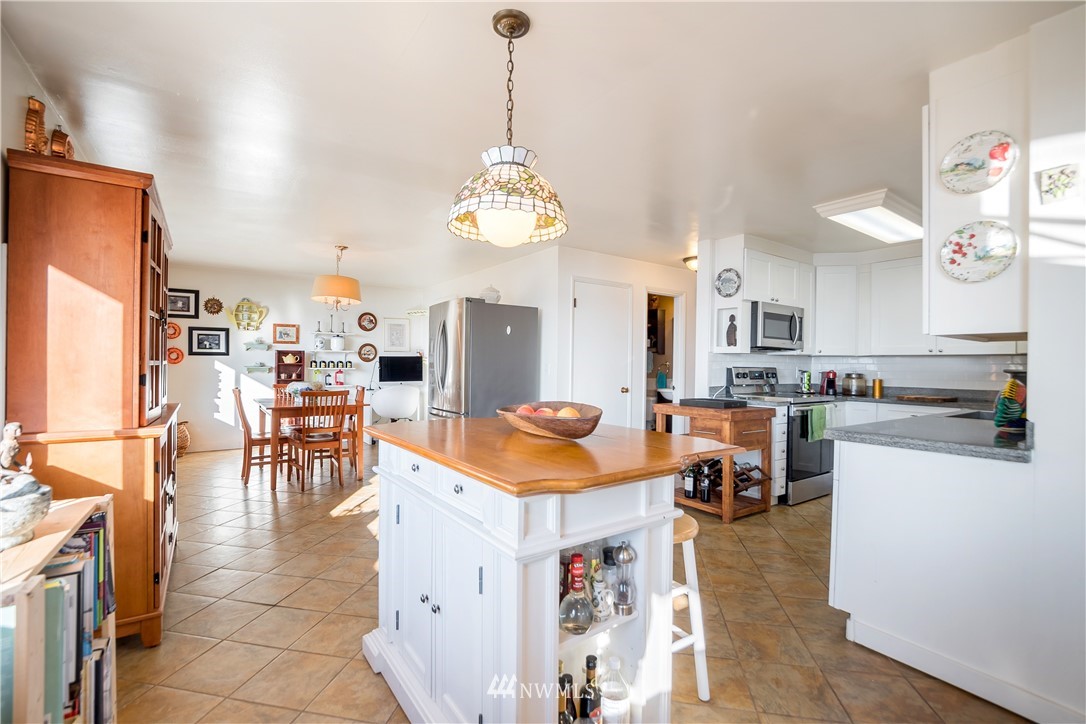 731 Woodmont Beach Road South Des Moines, WA 98198 - Photo 15 of 40 a room with stainless steel appliances kitchen island granite countertop furniture and a kitchen view