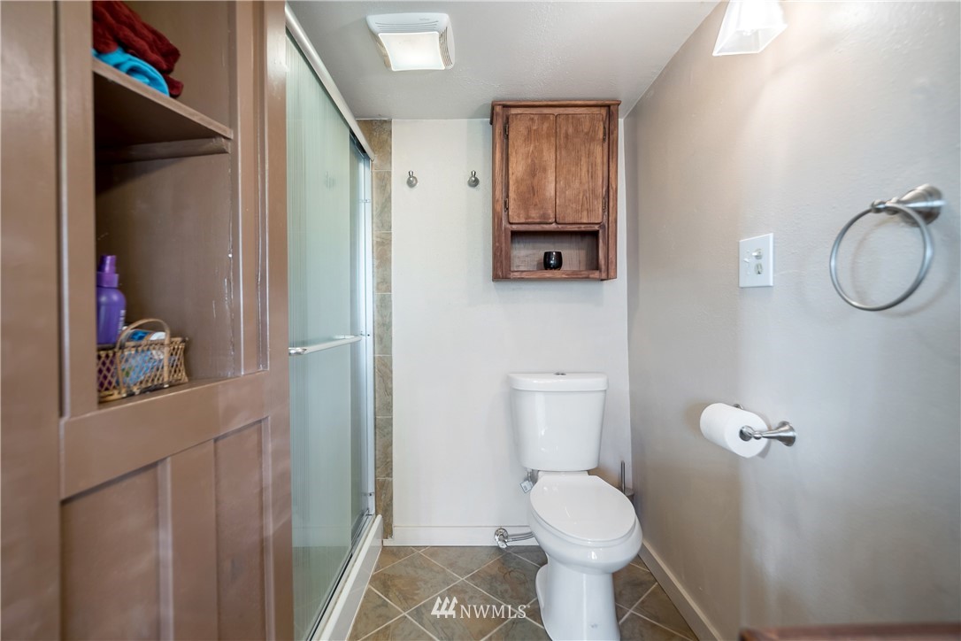 731 Woodmont Beach Road South Des Moines, WA 98198 - Photo 25 of 40 a white toilet sitting next to a bathroom sink