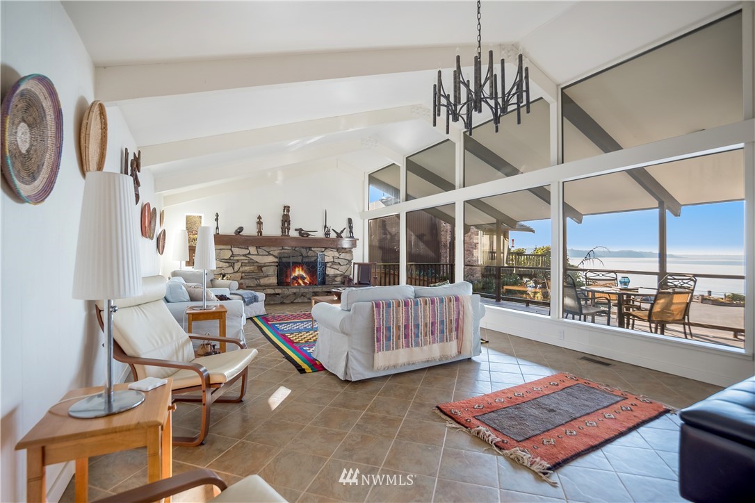 731 Woodmont Beach Road South Des Moines, WA 98198 - Photo 5 of 40 a living room with furniture a rug and a chandelier