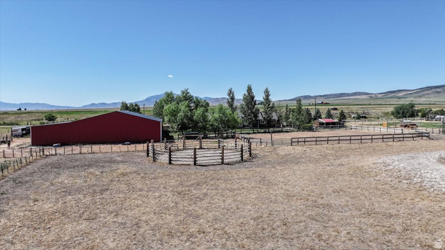 1634 West Arimo Road Arimo, ID 83214 - Photo 73 of 89 Expansive property featuring a red barn, round pen, and a large arena area