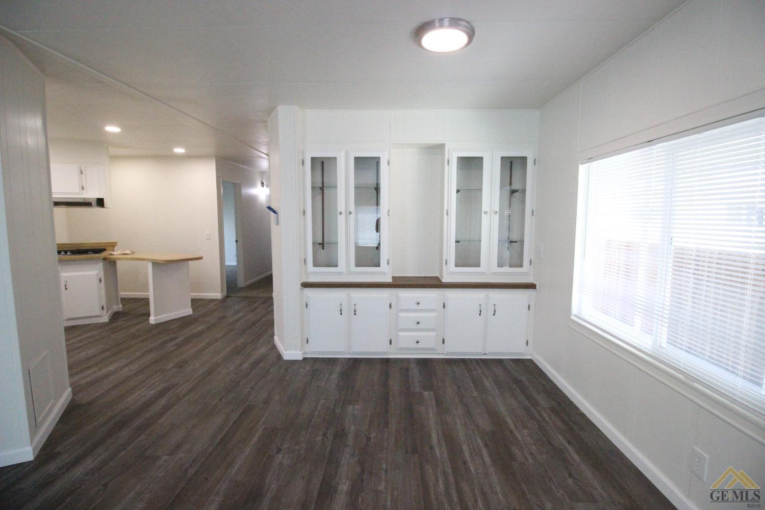 Undisclosed Address Bakersfield, CA 93308 - Photo 13 of 28 a view of kitchen with stainless steel appliances wooden floor and large window