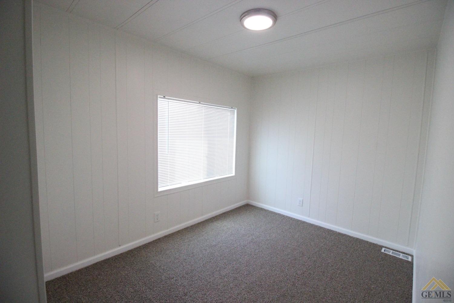 Undisclosed Address Bakersfield, CA 93308 - Photo 17 of 28 an empty room with a window