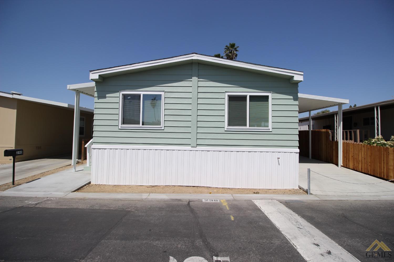 Undisclosed Address Bakersfield, CA 93308 - Photo 2 of 28 a front view of a house with a garage