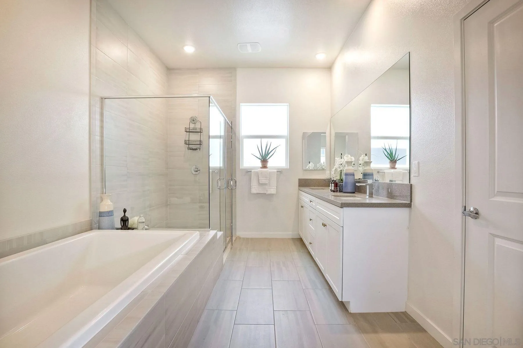 2040 Bravo Loop, Unit 4 Chula Vista, CA 91915 - Photo 12 of 25 a bathroom with a granite countertop sink a bathtub and shower