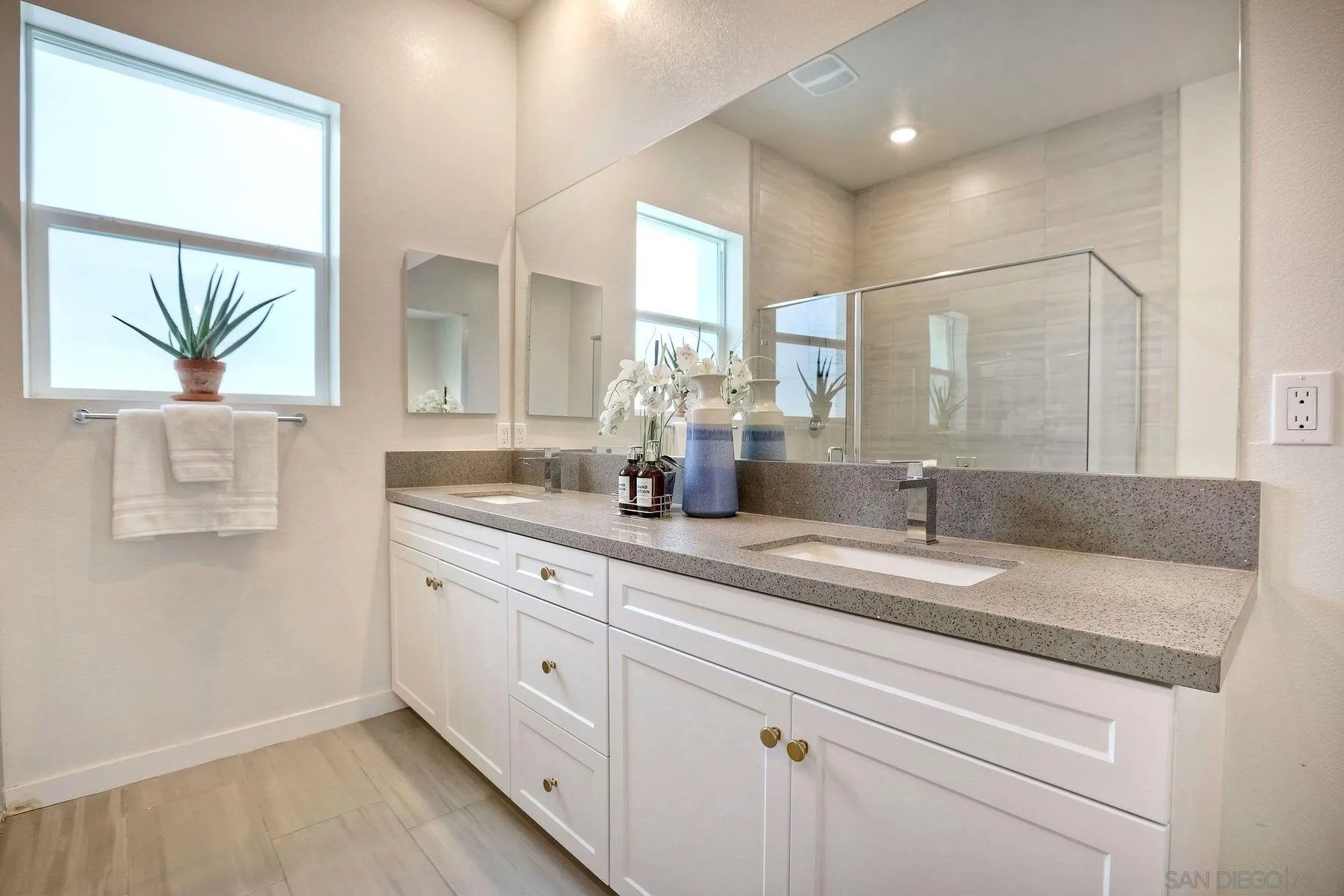 2040 Bravo Loop, Unit 4 Chula Vista, CA 91915 - Photo 13 of 25 a bathroom with double vanity and a mirror