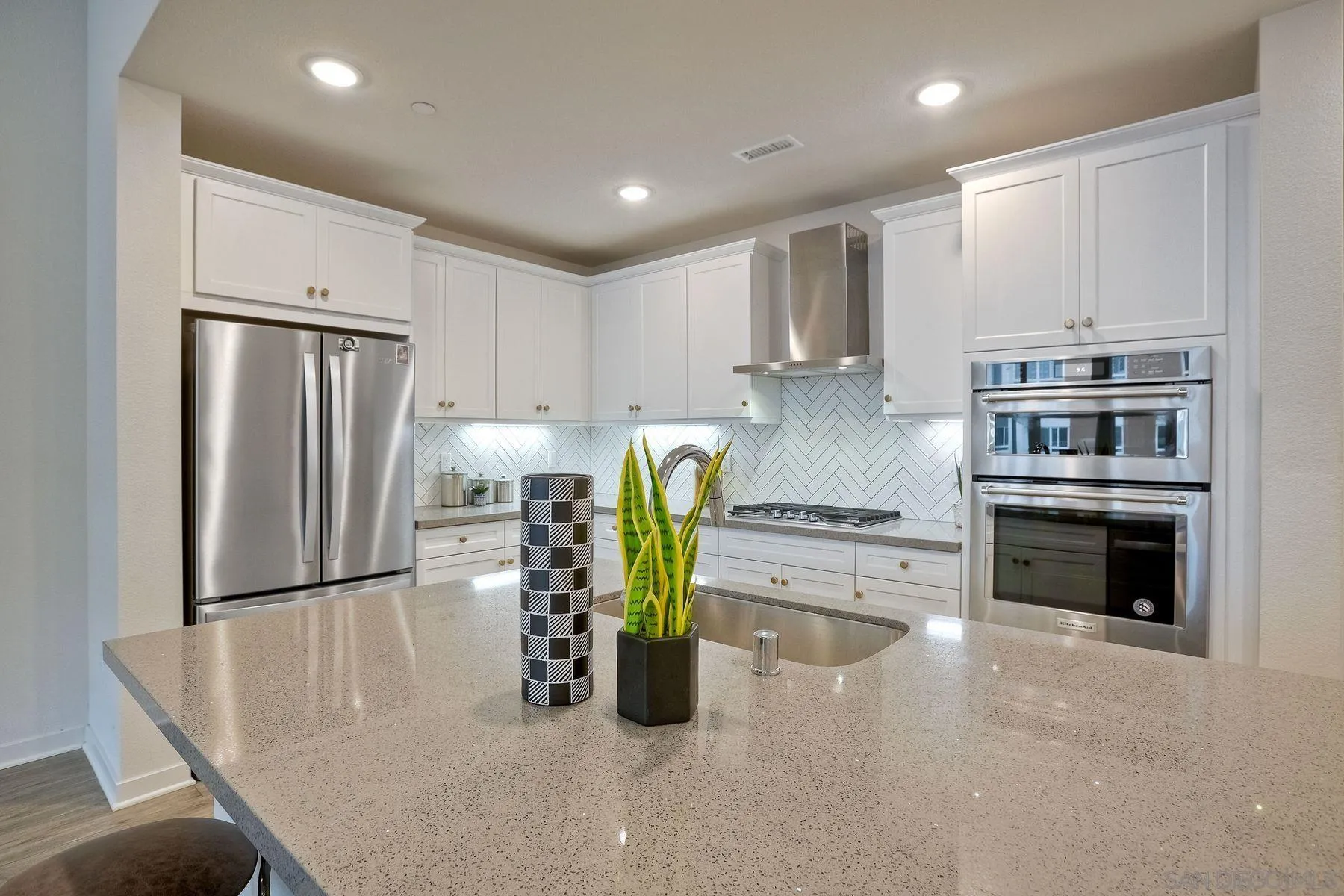 2040 Bravo Loop, Unit 4 Chula Vista, CA 91915 - Photo 22 of 25 a kitchen with stainless steel appliances granite countertop a refrigerator and a stove top oven