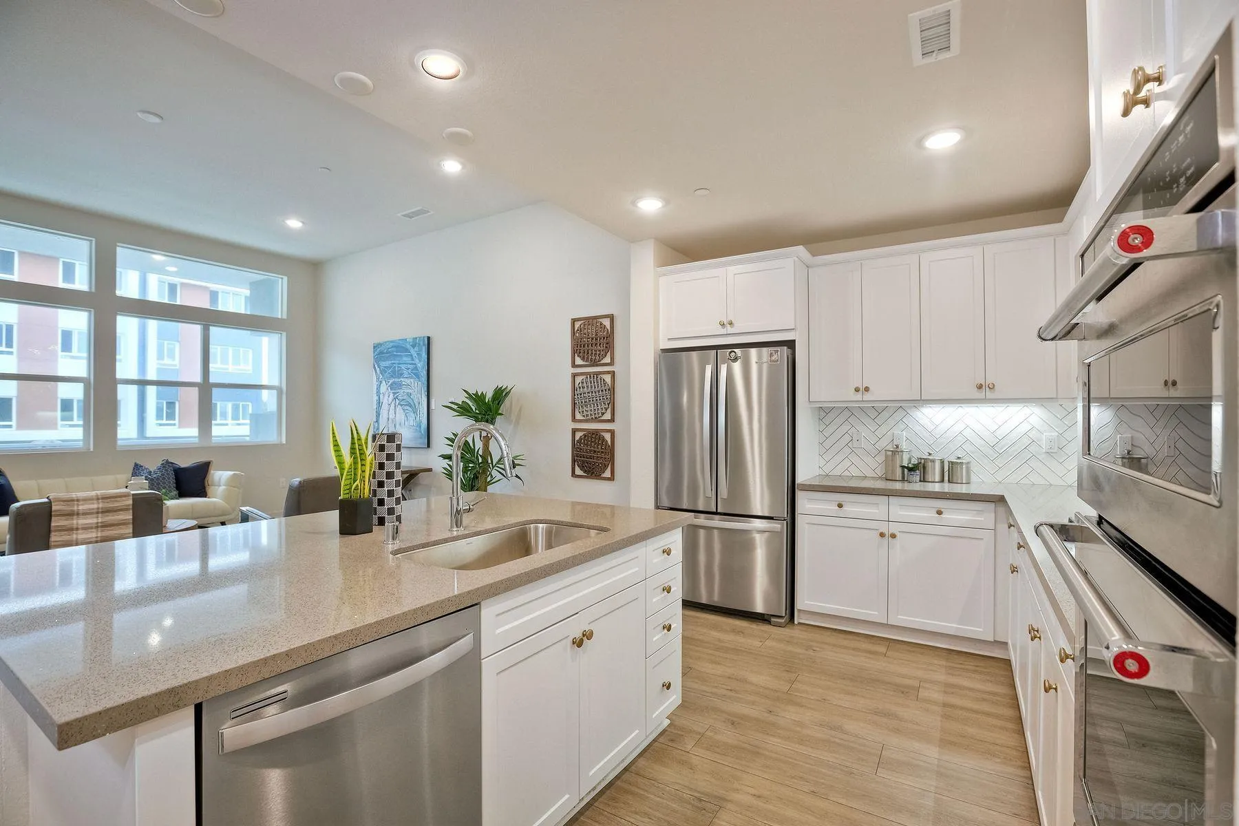 2040 Bravo Loop, Unit 4 Chula Vista, CA 91915 - Photo 23 of 25 a kitchen with refrigerator a sink and cabinets