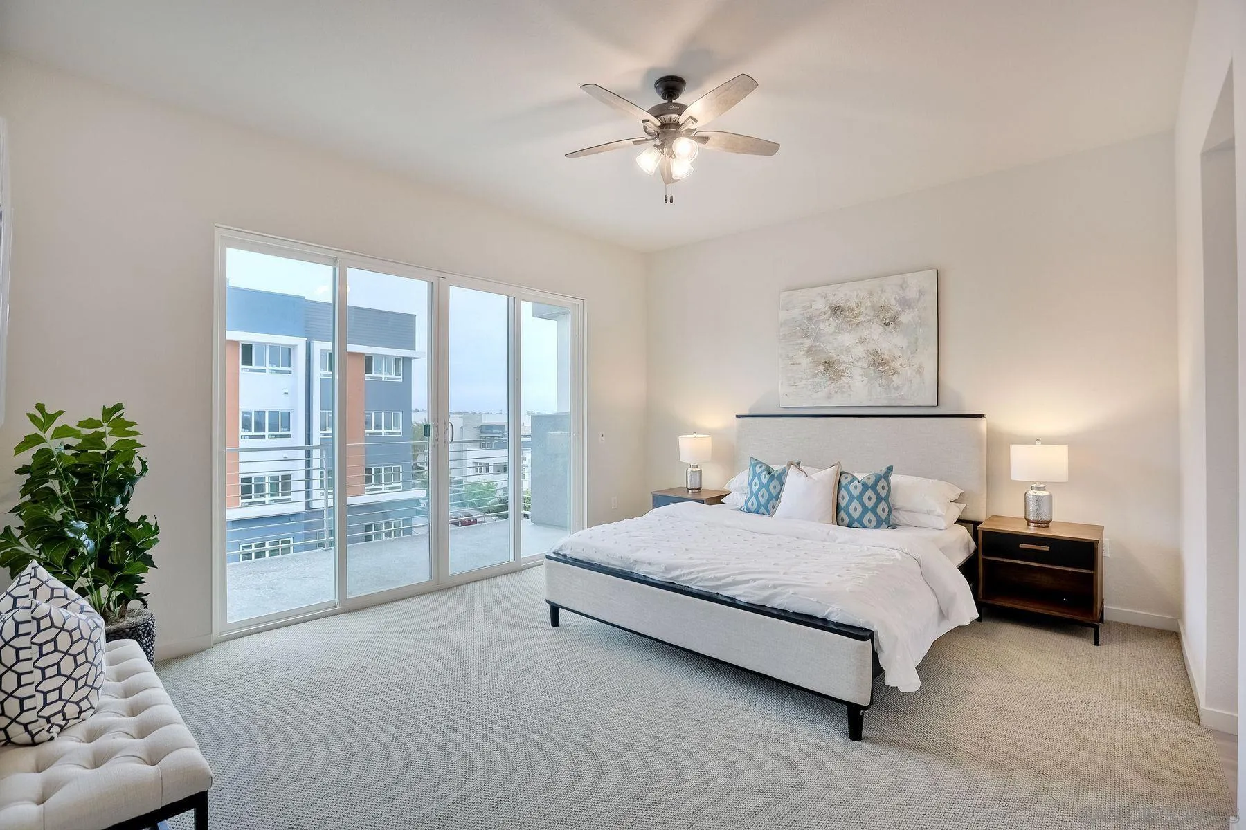 2040 Bravo Loop, Unit 4 Chula Vista, CA 91915 - Photo 8 of 25 a spacious bedroom with a large bed and a chandelier