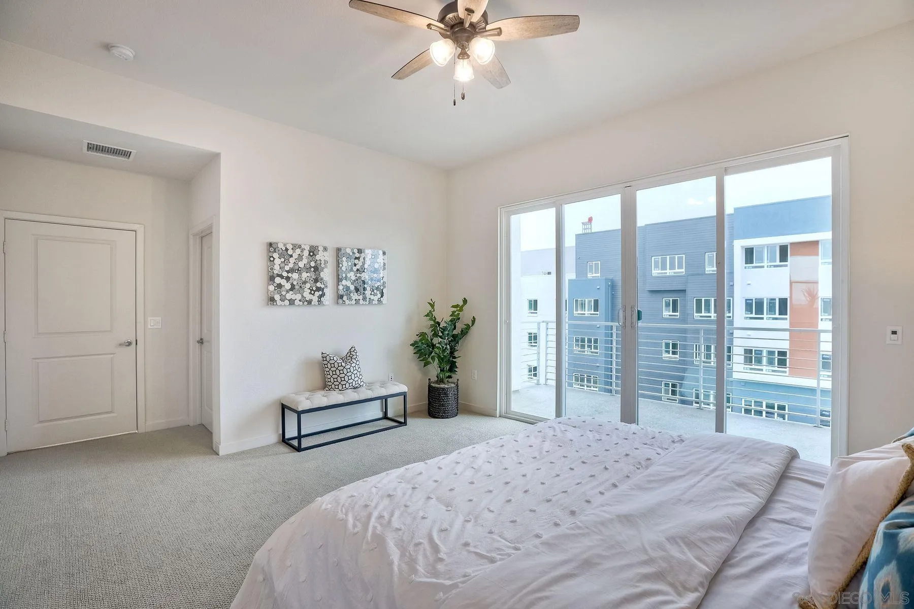 2040 Bravo Loop, Unit 4 Chula Vista, CA 91915 - Photo 9 of 25 a bedroom with a large bed and a chandelier