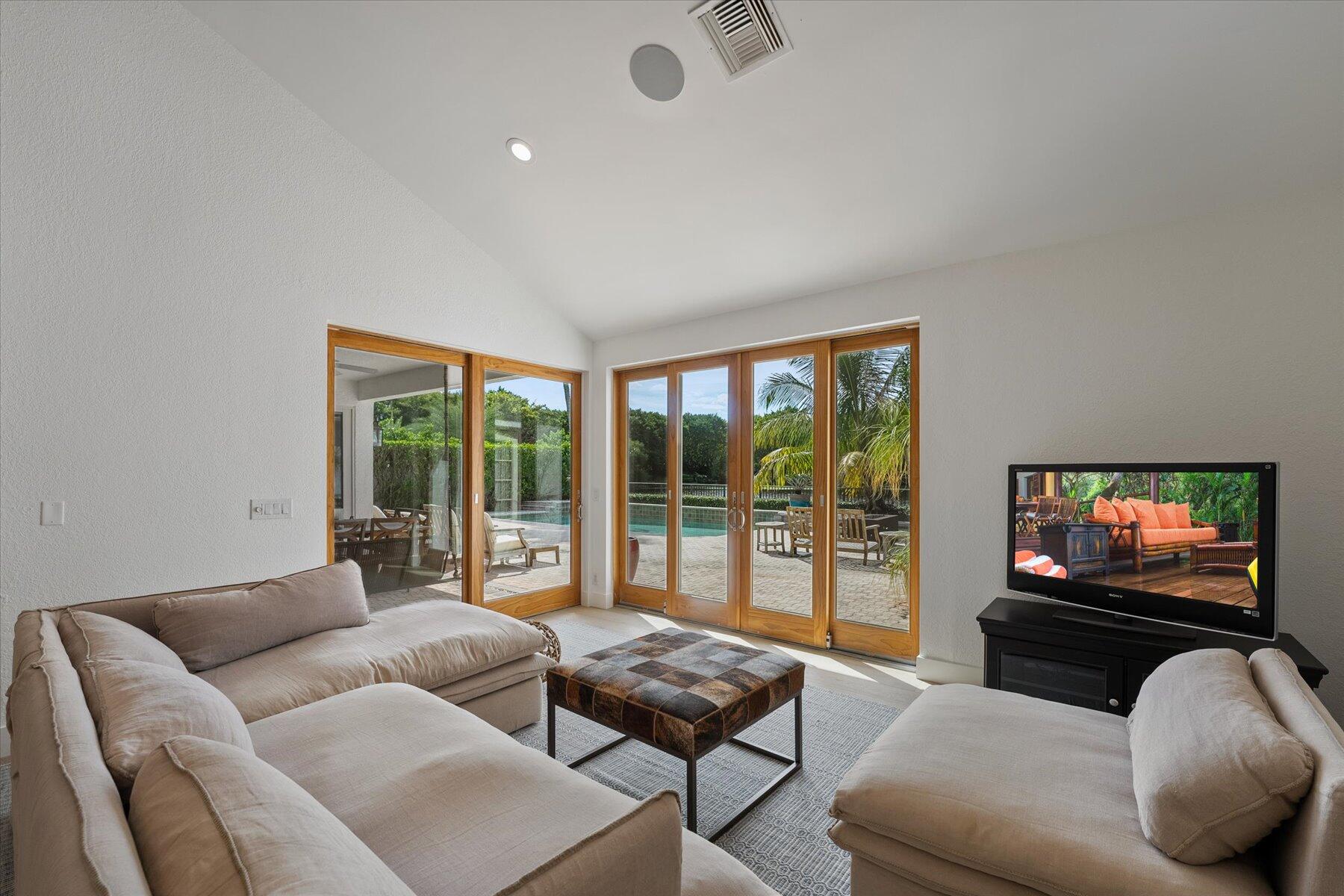 2821 Bent Cypress Road Wellington, FL 33414 - Photo 22 of 64 a living room with furniture a large window and a flat screen tv
