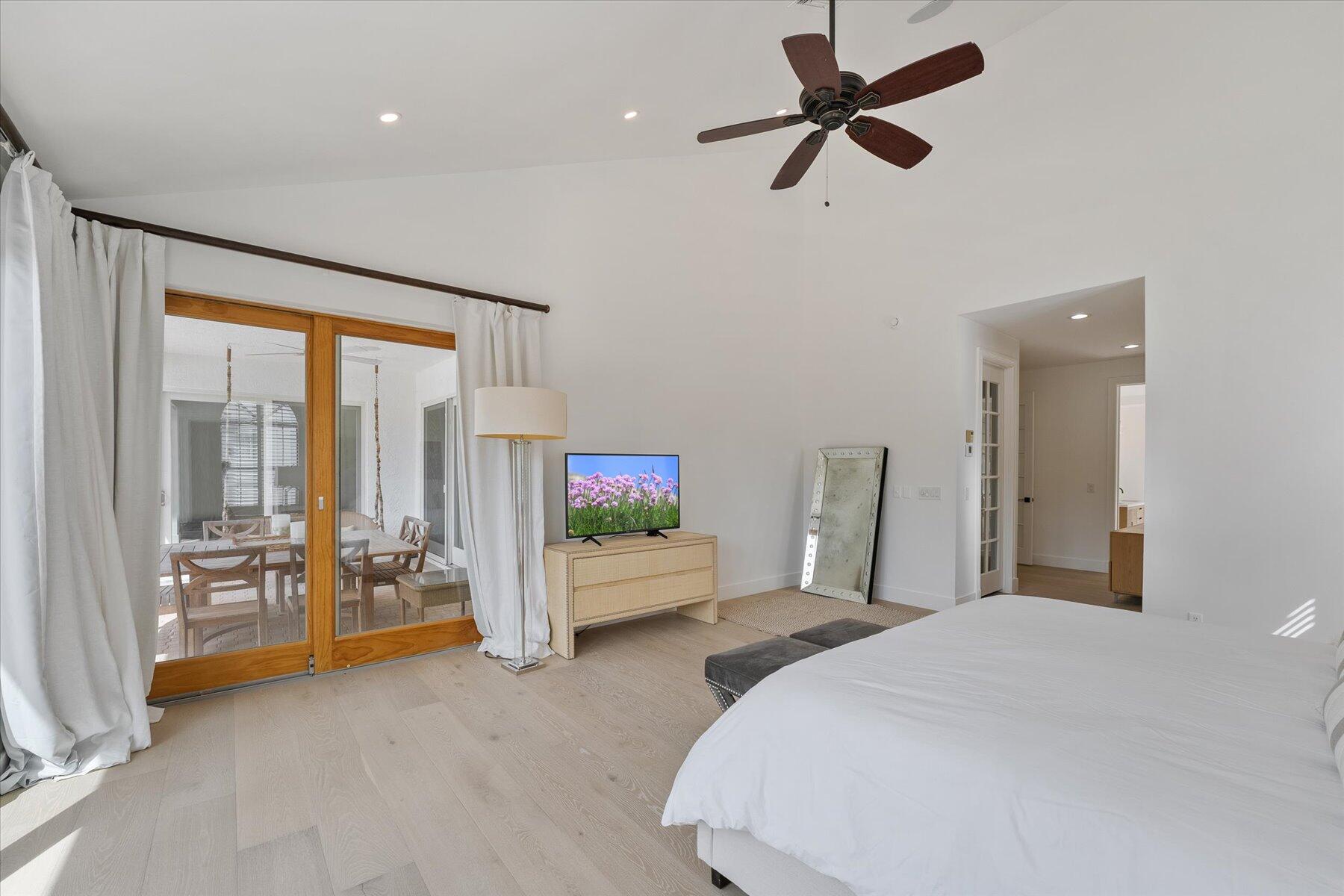 2821 Bent Cypress Road Wellington, FL 33414 - Photo 26 of 64 a bedroom with a bed and a large window