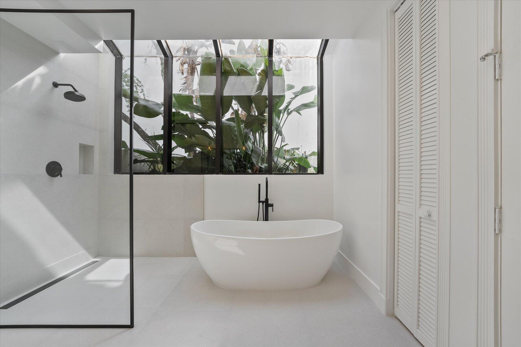 2821 Bent Cypress Road Wellington, FL 33414 - Photo 29 of 64 a bathroom with a bathtub and next to a shower