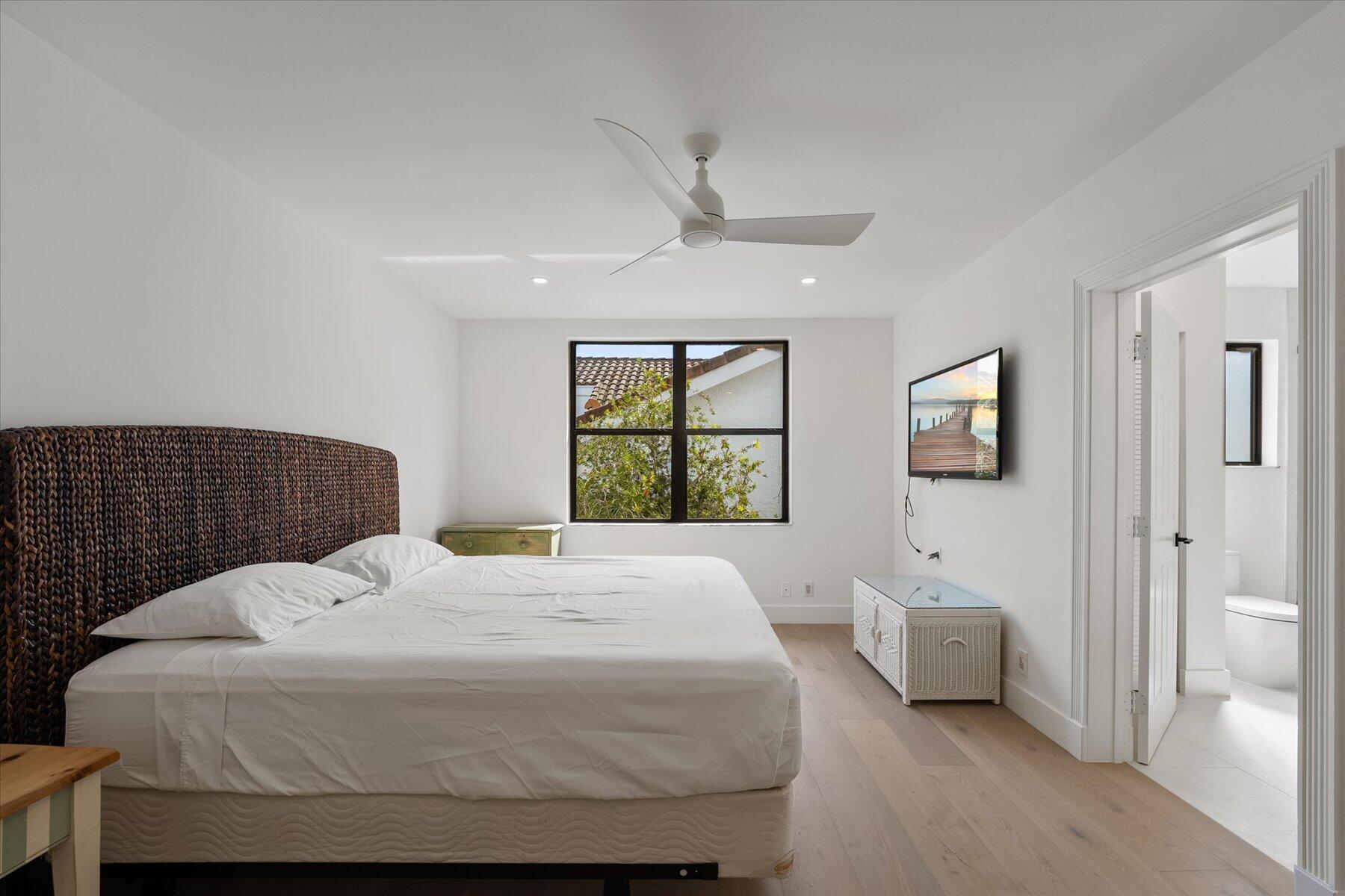 2821 Bent Cypress Road Wellington, FL 33414 - Photo 37 of 64 a bedroom with a bed and a window