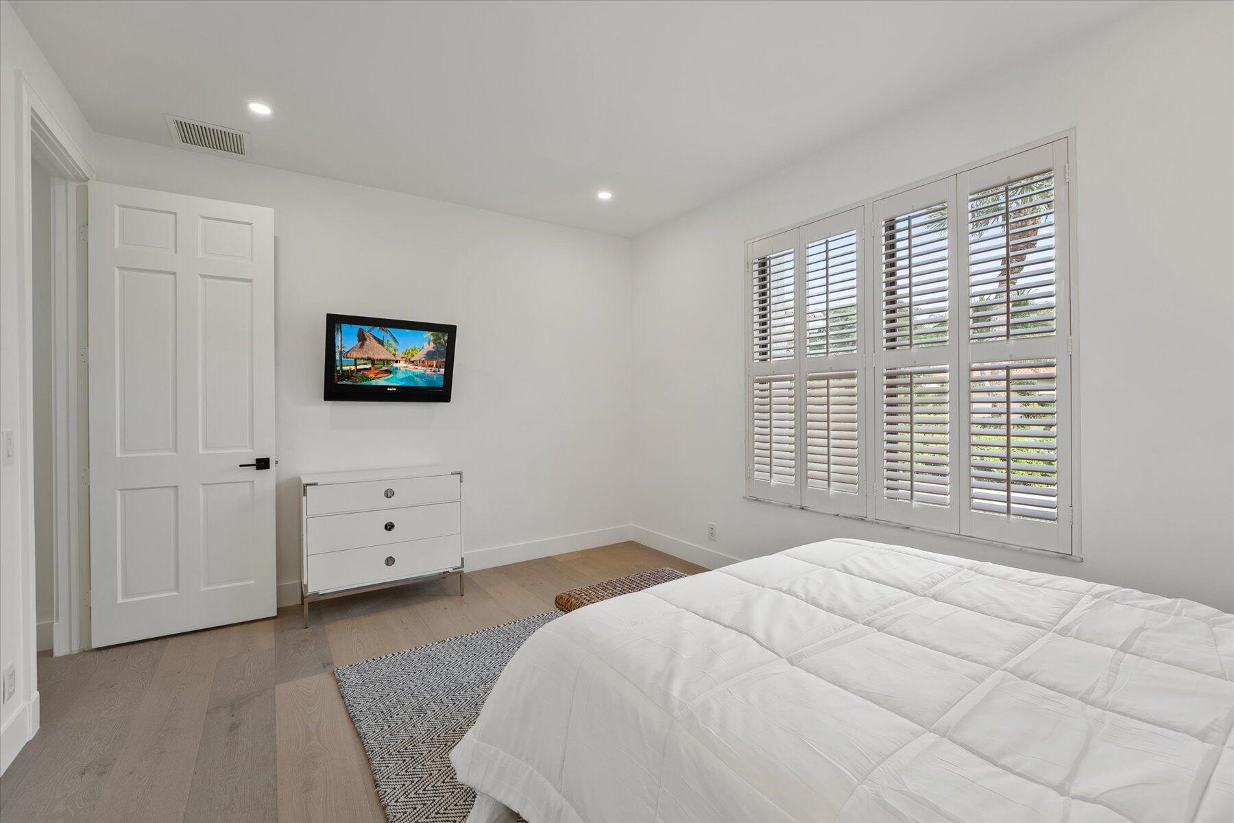 2821 Bent Cypress Road Wellington, FL 33414 - Photo 44 of 64 a bedroom with a bed and a tv