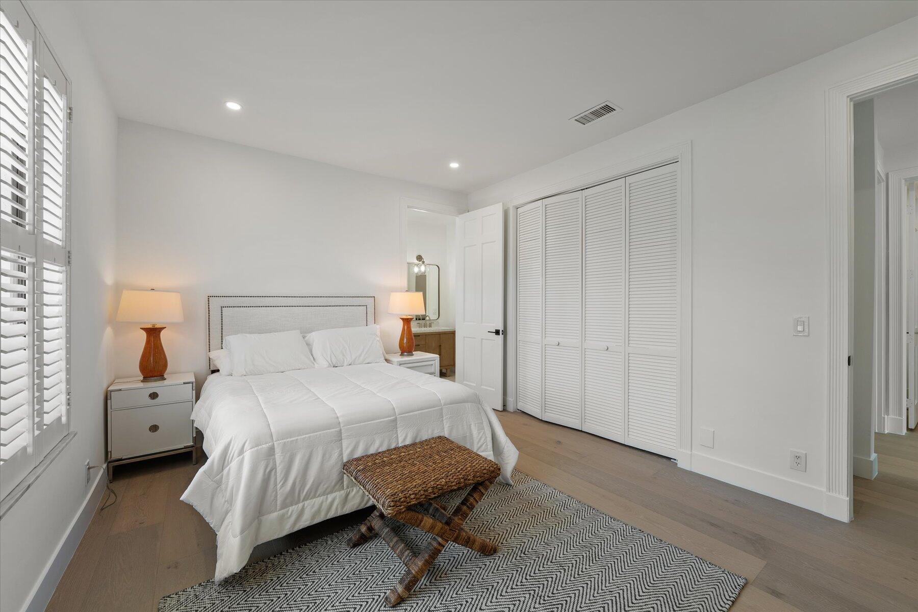 2821 Bent Cypress Road Wellington, FL 33414 - Photo 45 of 64 a bedroom with a bed and a lamp