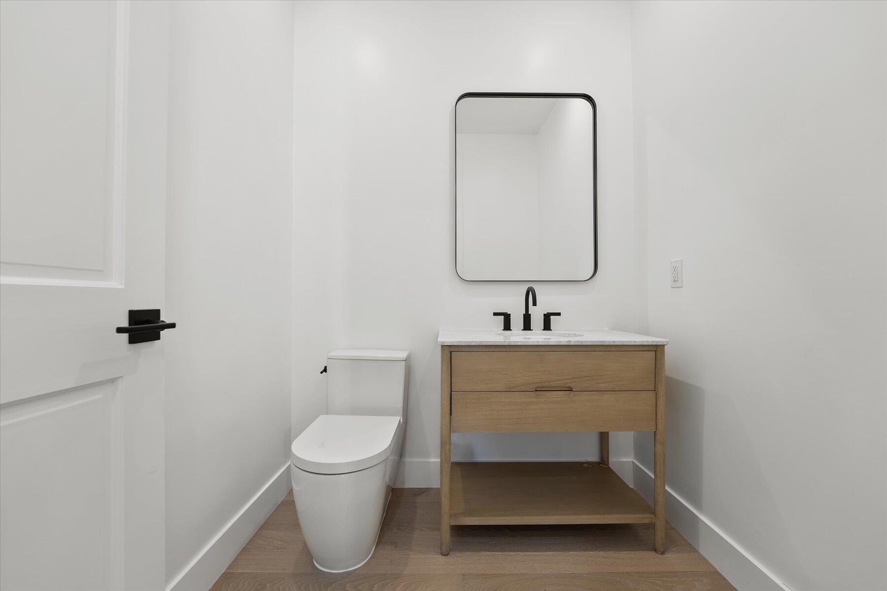 2821 Bent Cypress Road Wellington, FL 33414 - Photo 46 of 64 a bathroom with a toilet a sink and mirror
