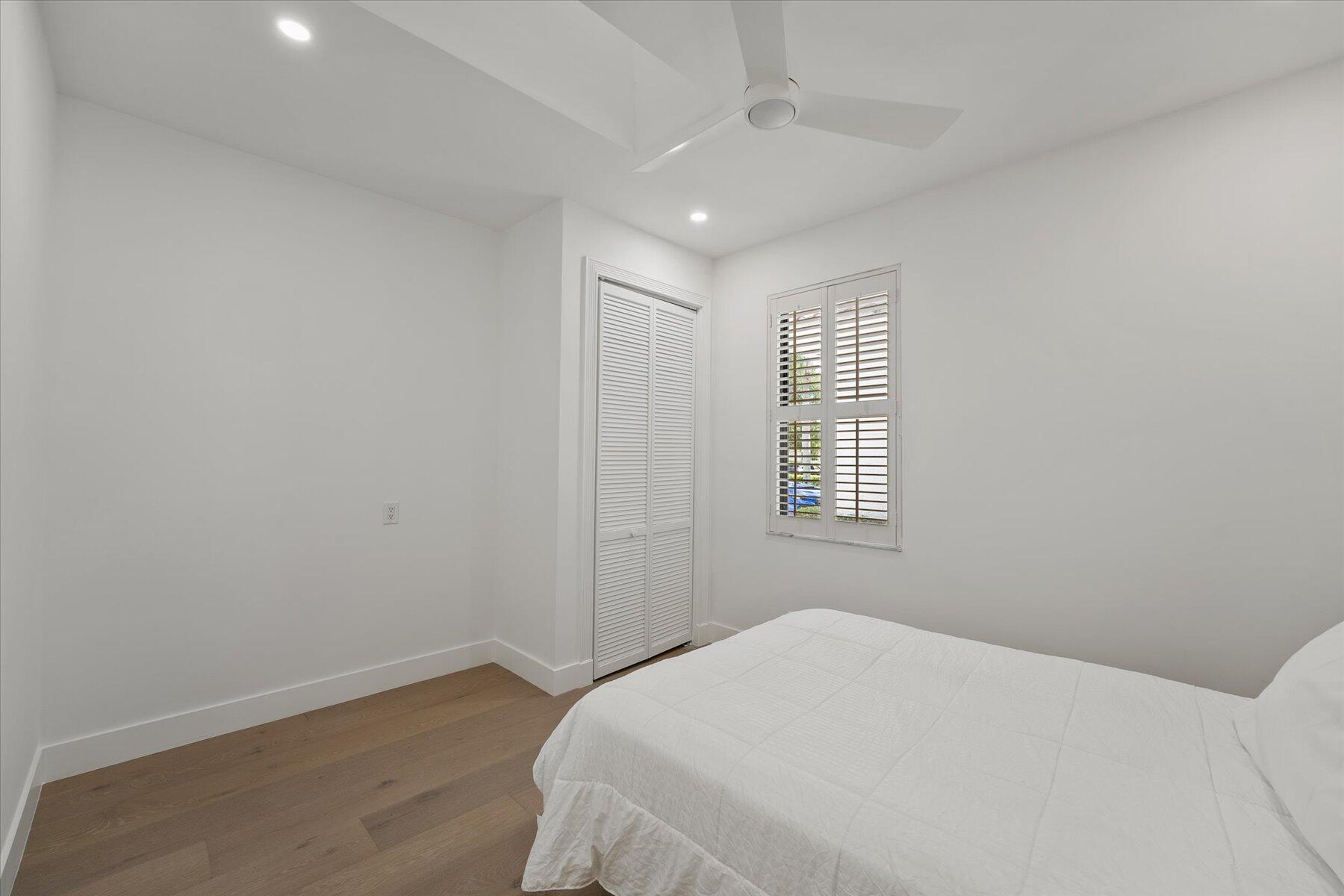 2821 Bent Cypress Road Wellington, FL 33414 - Photo 48 of 64 a bedroom with a bed and a window