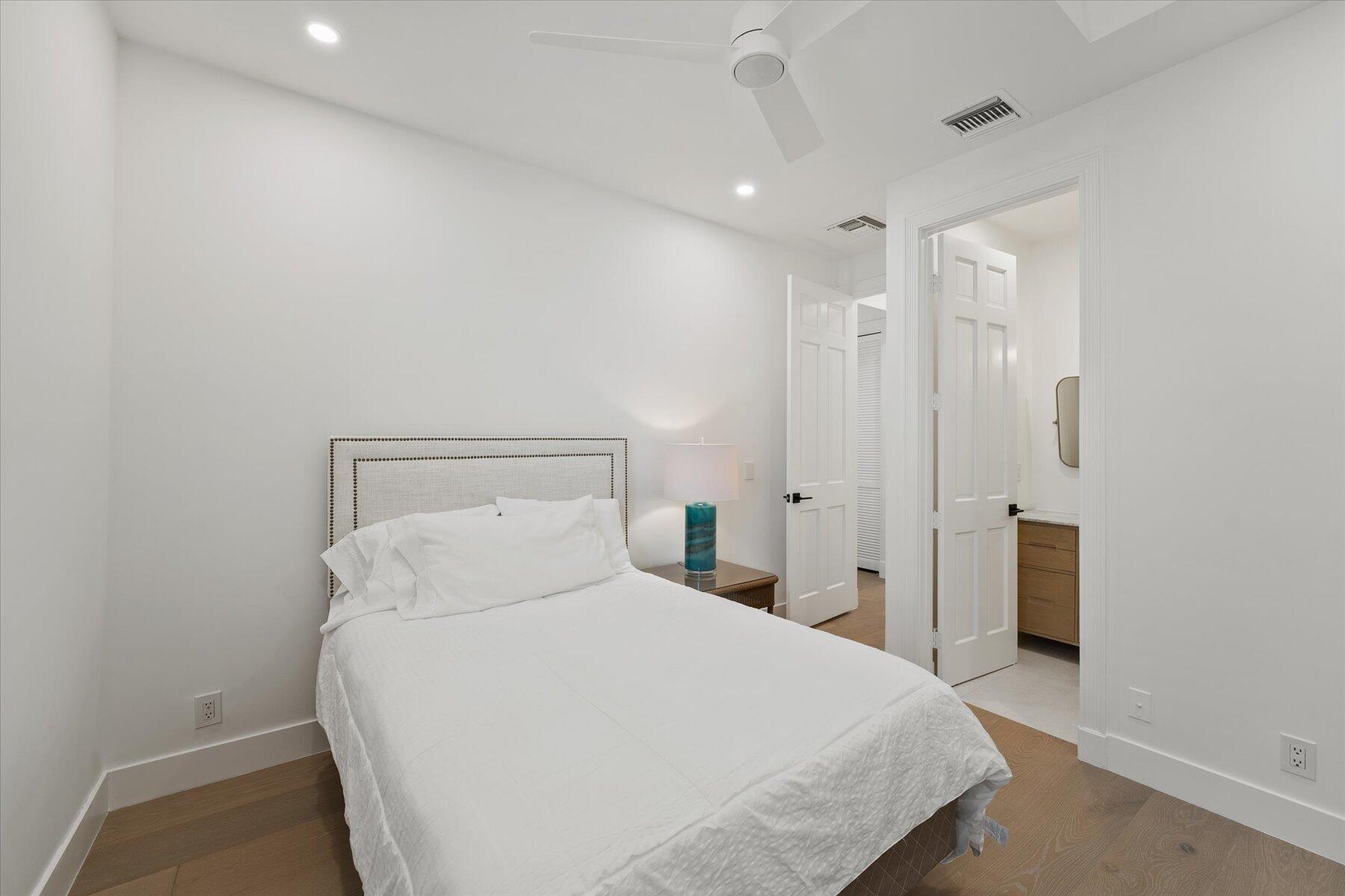 2821 Bent Cypress Road Wellington, FL 33414 - Photo 49 of 64 a large bed in a white room with closet