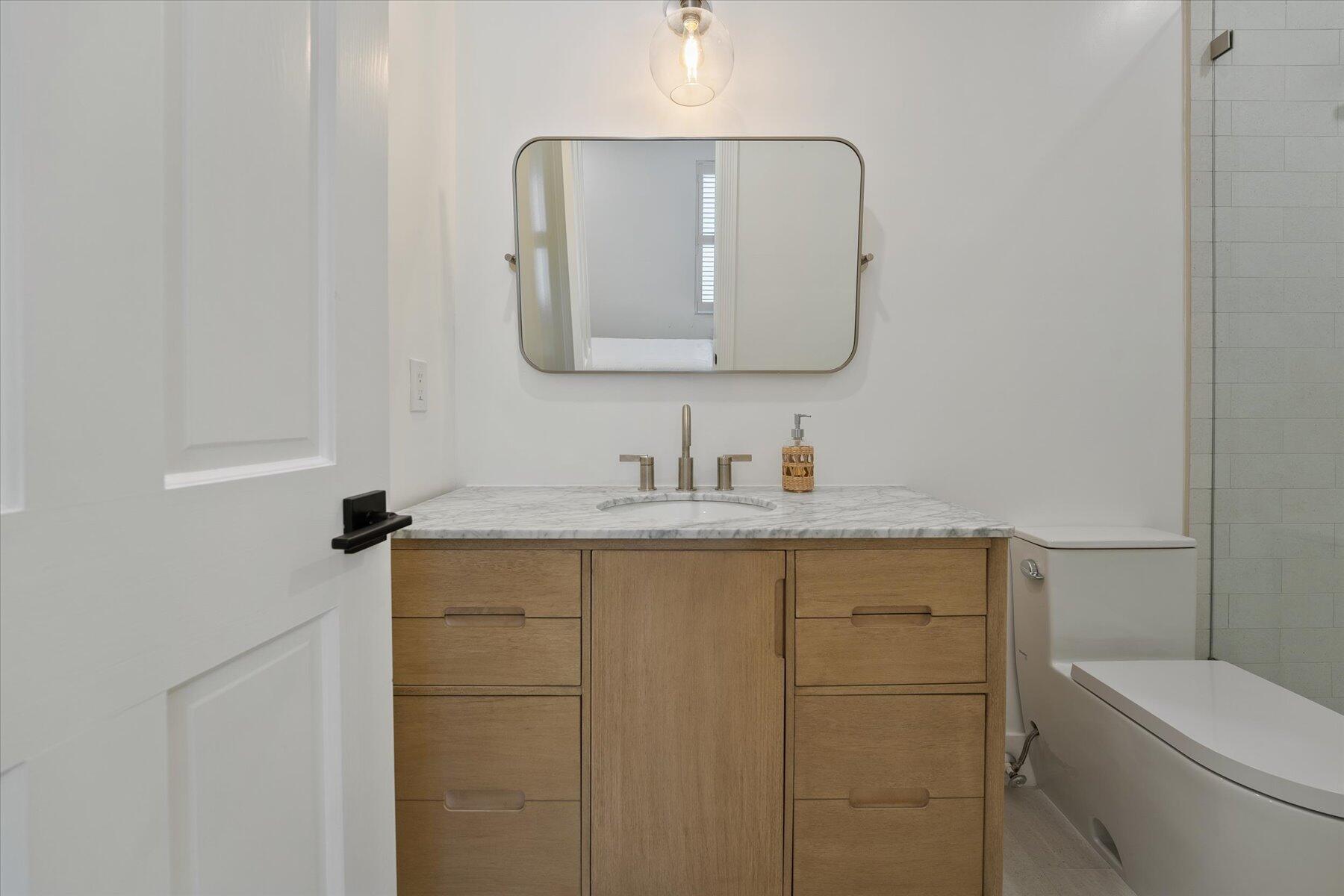 2821 Bent Cypress Road Wellington, FL 33414 - Photo 50 of 64 a bathroom with a granite countertop toilet sink and mirror