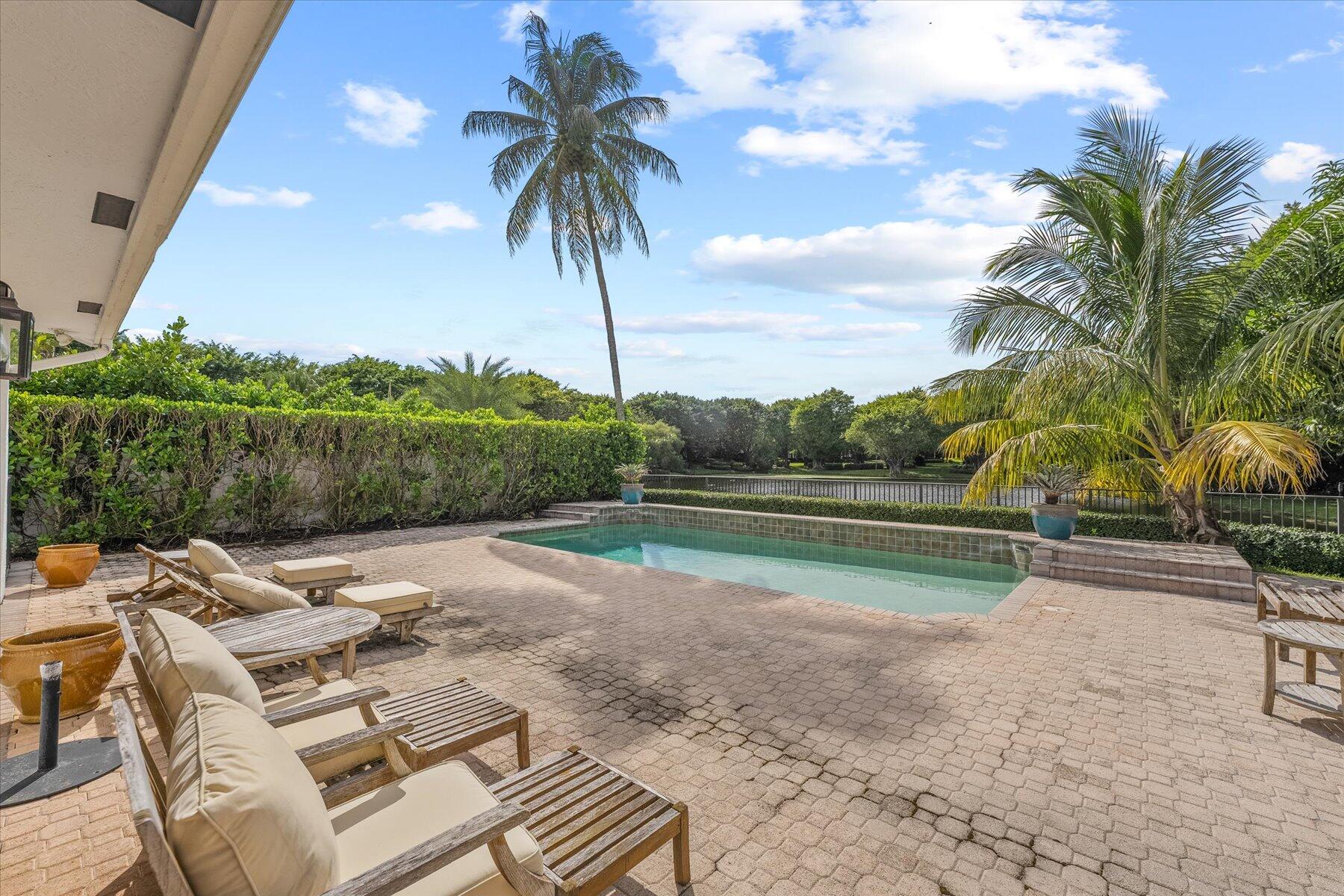 2821 Bent Cypress Road Wellington, FL 33414 - Photo 54 of 64 a view of swimming pool with a table and chairs