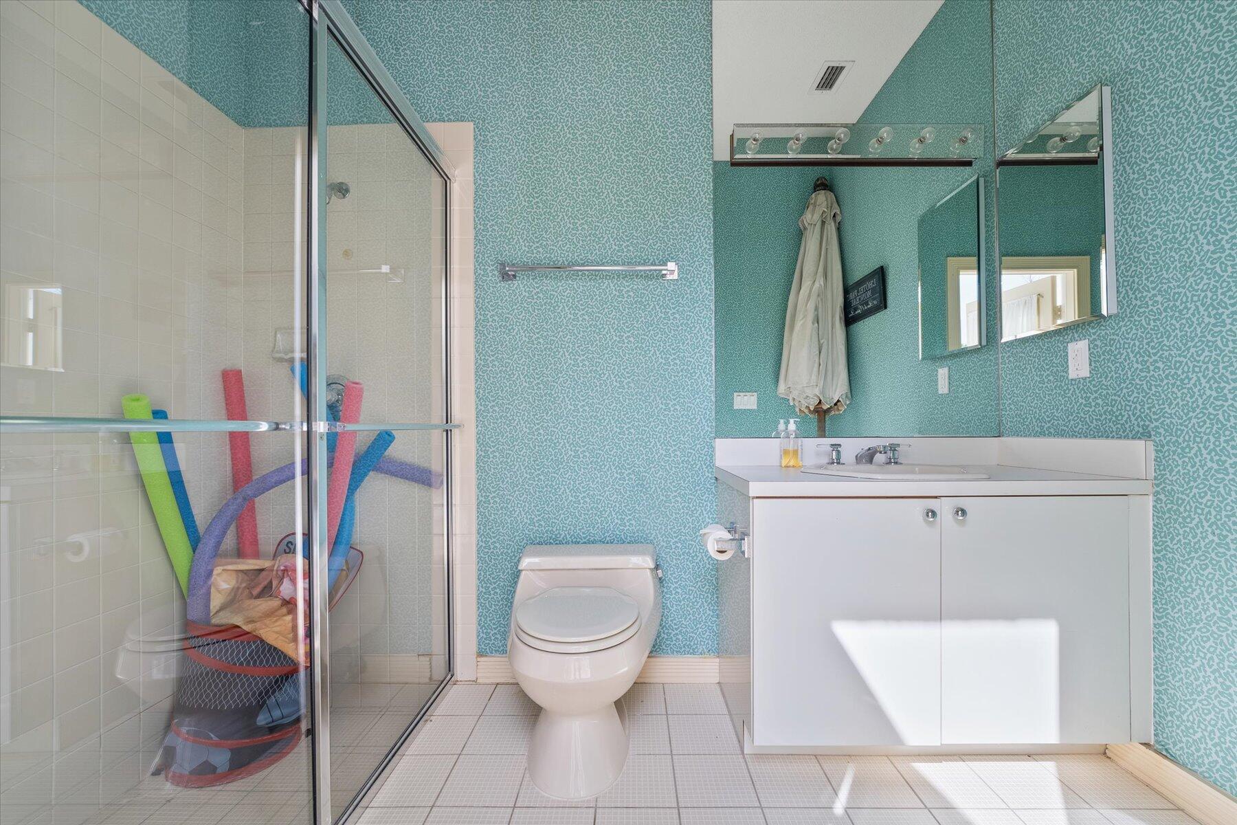 2821 Bent Cypress Road Wellington, FL 33414 - Photo 64 of 64 a bathroom with a toilet sink and mirror