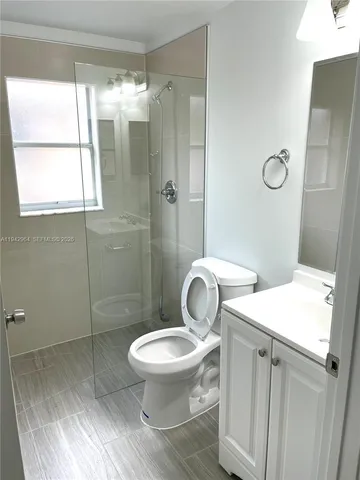a white toilet sitting next to a bathroom sink