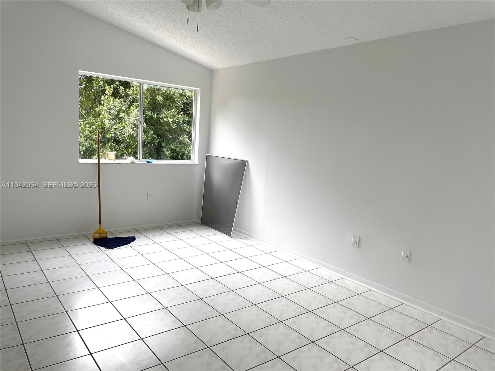 15870 Southwest 85th Lane Miami, FL 33193 - Photo 7 of 18 a bedroom with a bed and a window