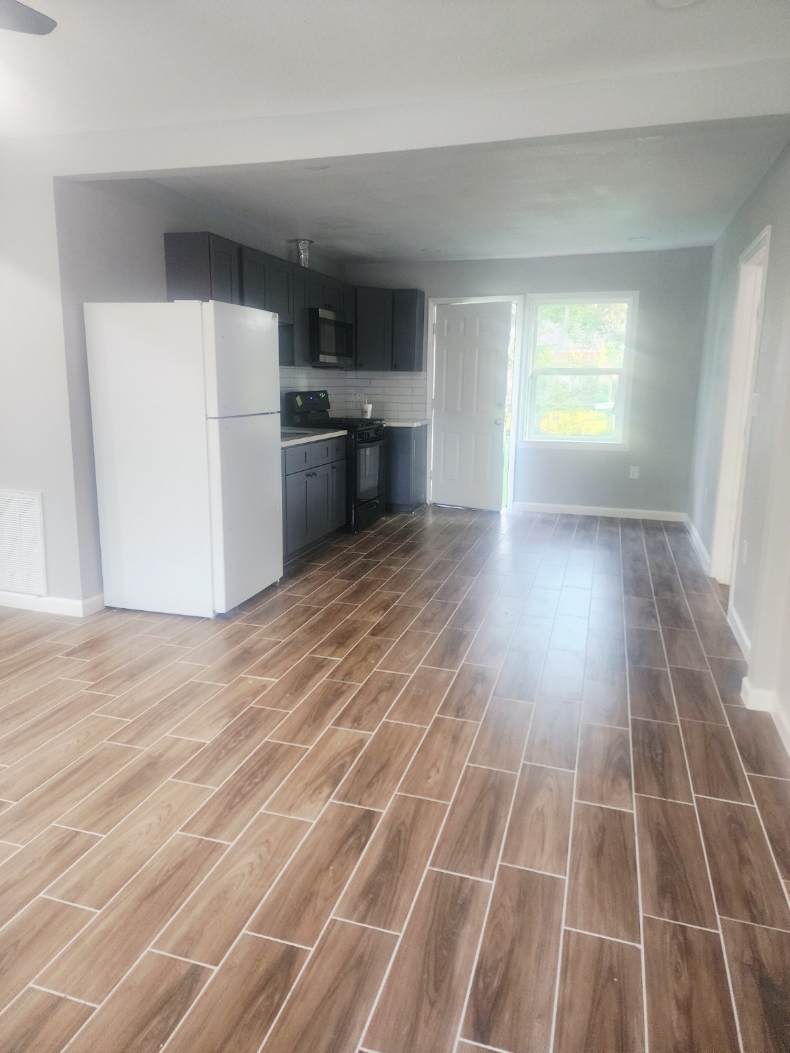 3934 Alice Street Houston, TX 77021 - Photo 2 of 9 a view of a room with wooden floor and electronic appliances