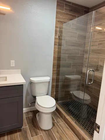 a bathroom with a toilet and a shower