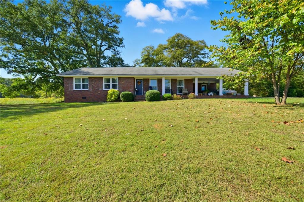 8730 Jot Em Down Road Gainesville, GA 30506 - Photo 1 of 1 a front view of a house with a garden