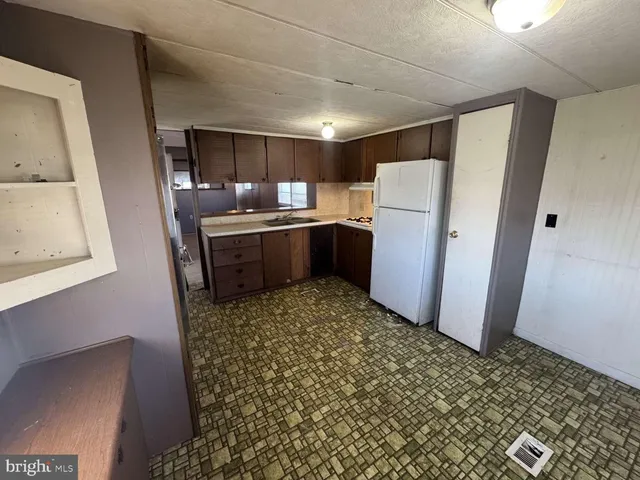 a kitchen with a refrigerator and a stove