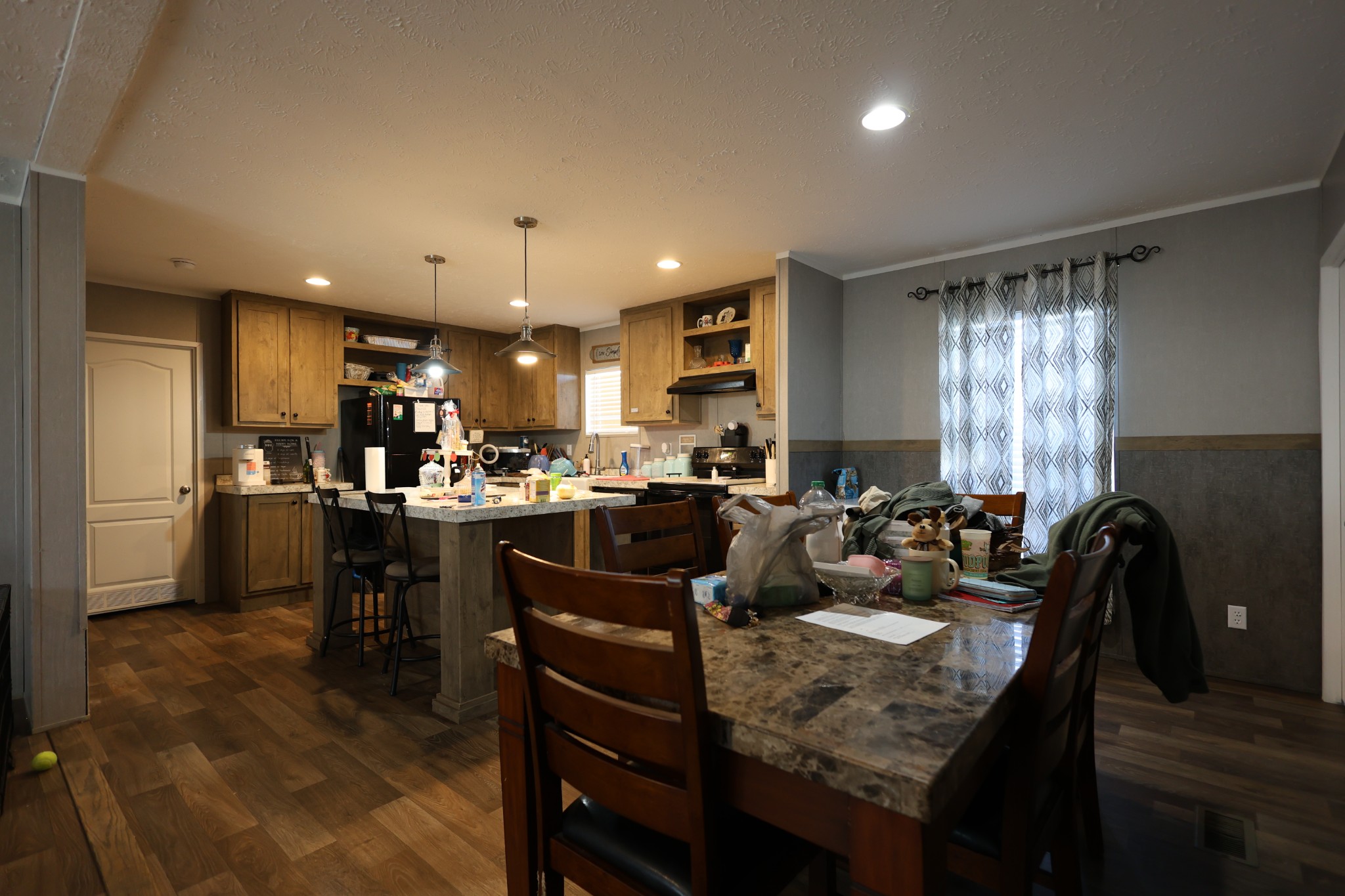 298 Fly Road Shelbyville, TN 37160 - Photo 4 of 21 a kitchen with a dining table chairs and refrigerator