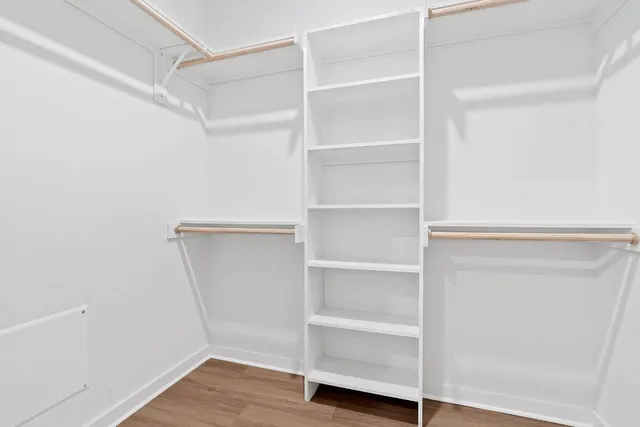 a view of walk in closet with empty racks