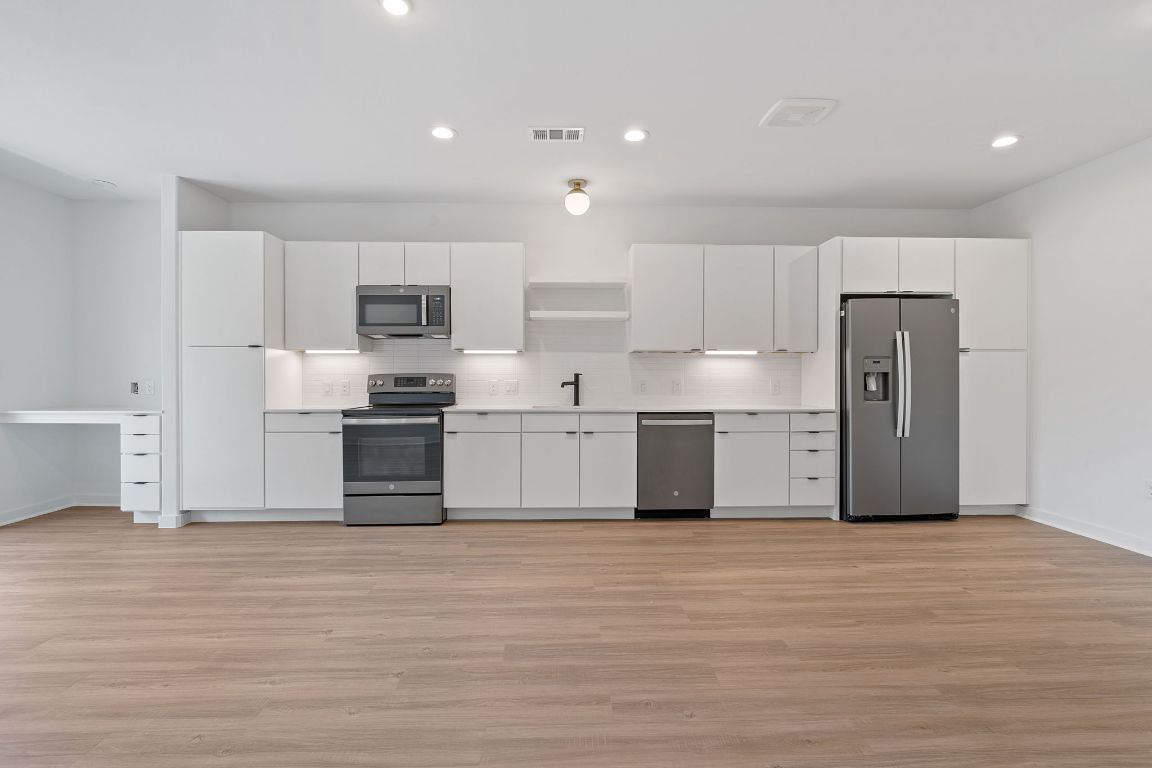 100 West Mockingbird Lane, Unit 308 Austin, TX 78745 - Photo 18 of 23 a kitchen with stainless steel appliances a refrigerator sink and cabinets