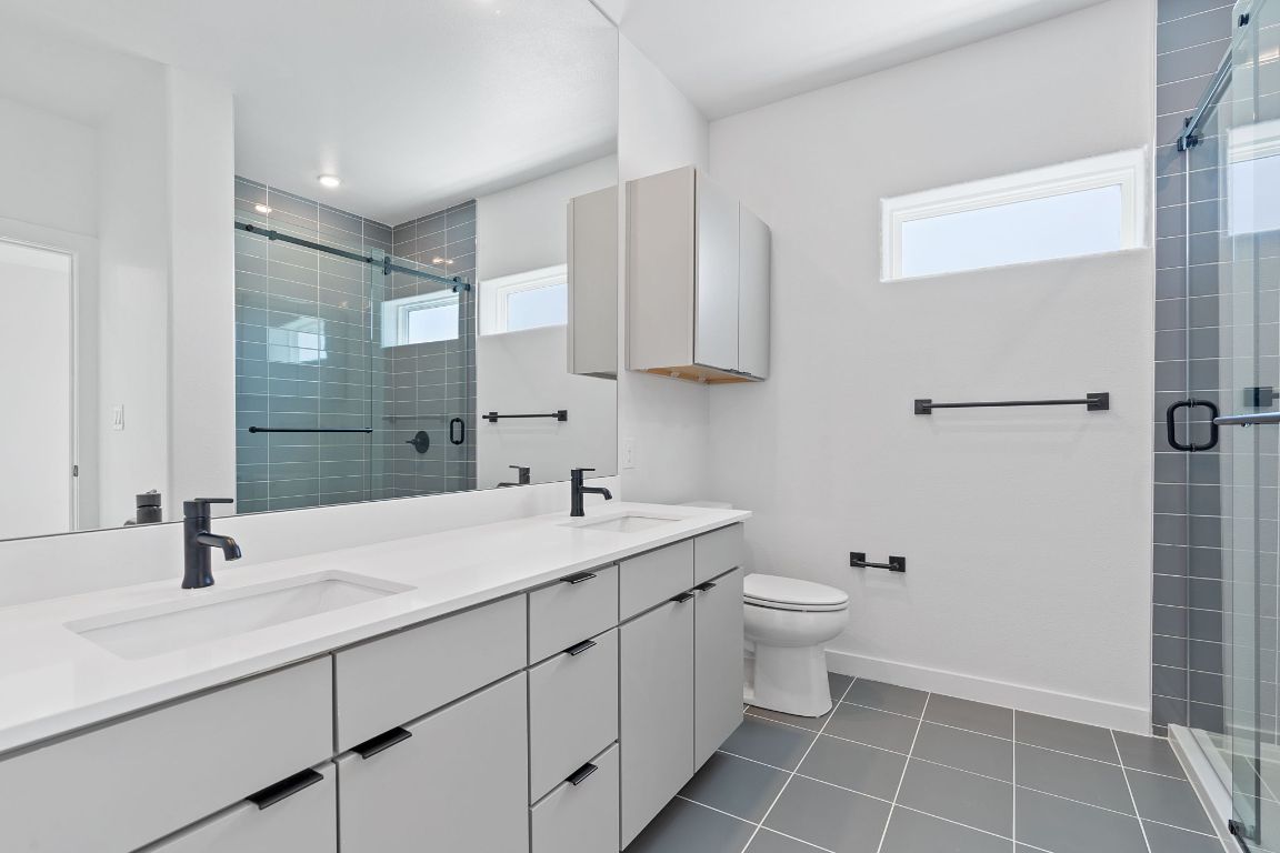 100 West Mockingbird Lane, Unit 308 Austin, TX 78745 - Photo 6 of 23 a bathroom with a sink toilet and shower
