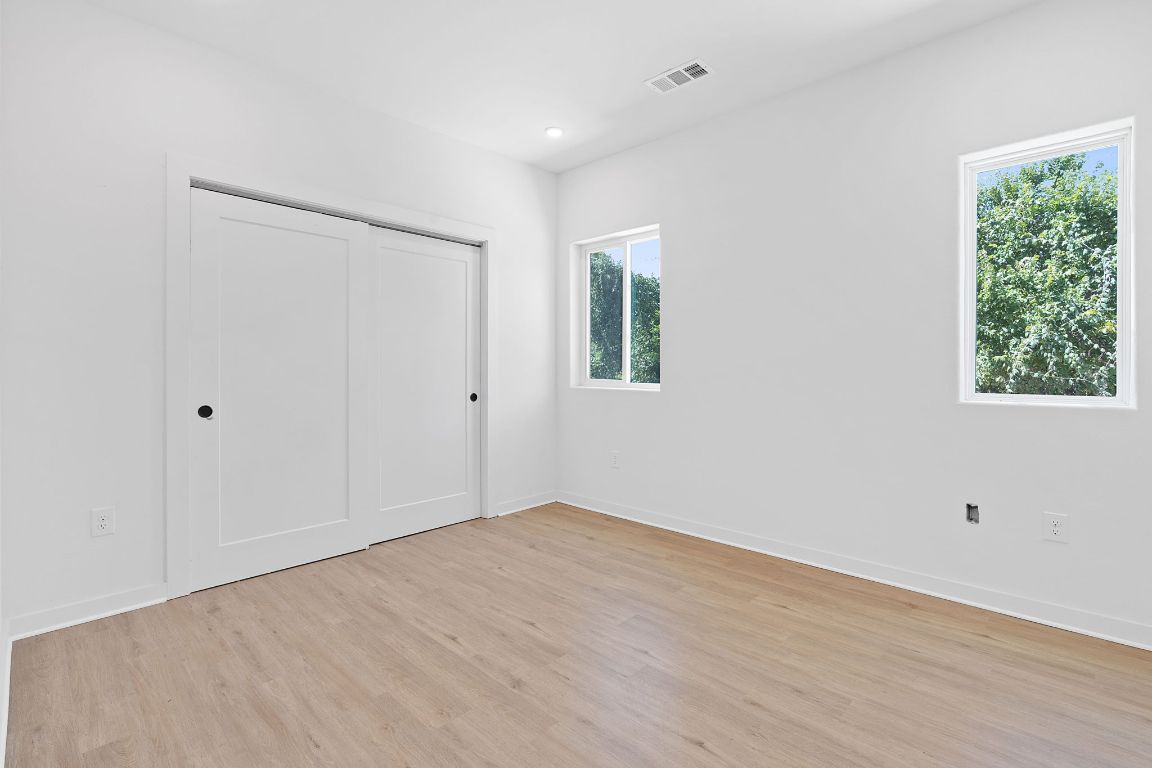 100 West Mockingbird Lane, Unit 308 Austin, TX 78745 - Photo 10 of 23 a view of an empty room with wooden floor and a window