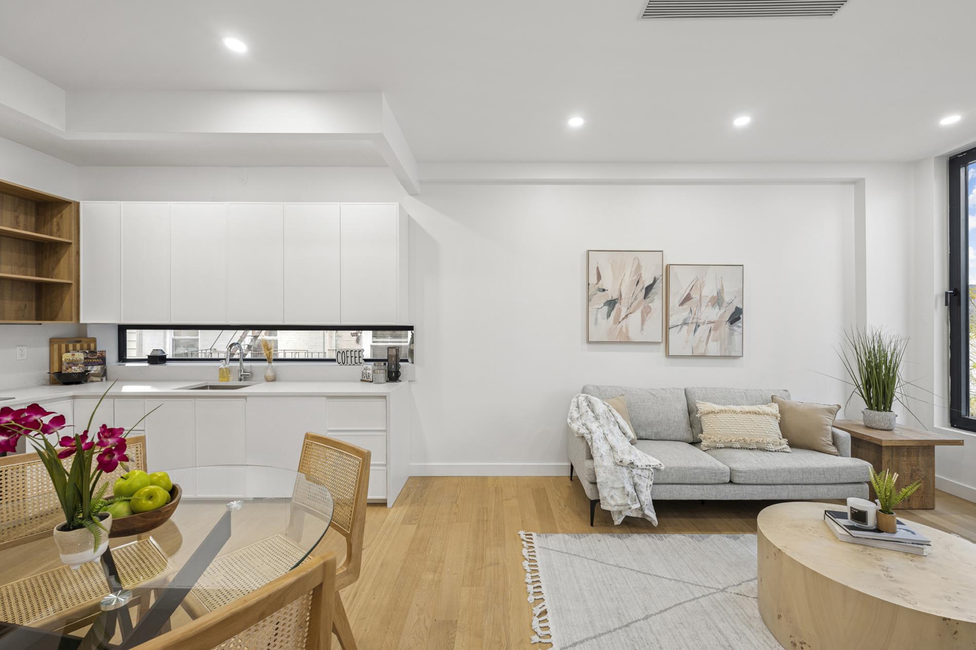 54 Dupont Street, Unit 2F Brooklyn, NY 11222 - Photo 2 of 10 a living room with furniture and flowers