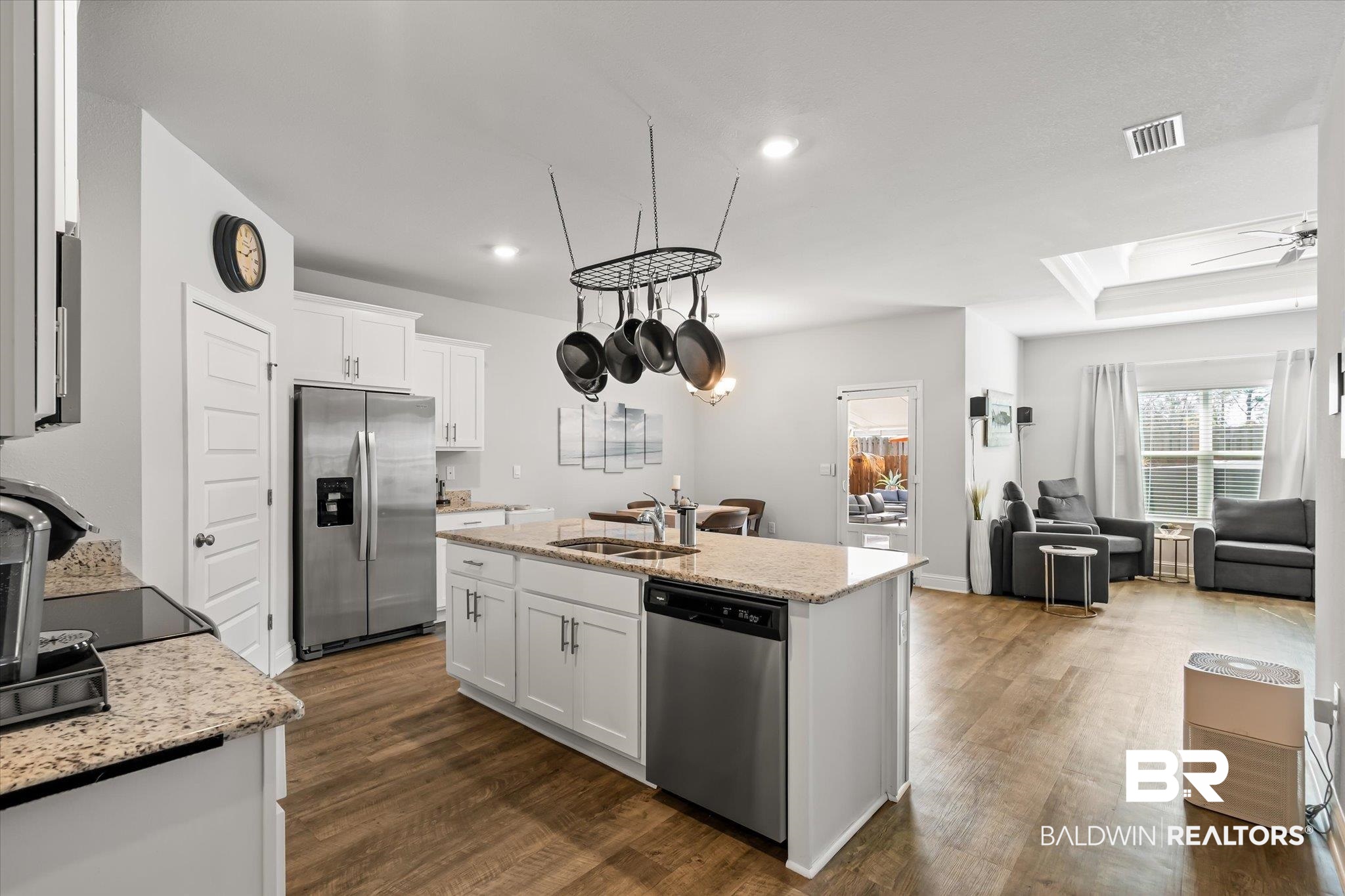 23246 Lieutenant Avenue Foley, AL 36535 - Photo 12 of 36 Kitchen with dark hardwood / wood-style floors, sink, white cabinets, a kitchen island with sink, and stainless steel appliances