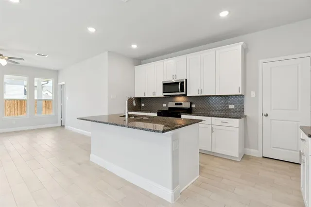 a front view of a house with a garden and outdoor seating