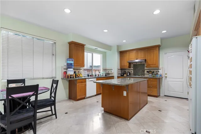 a kitchen with a sink a counter top space and stainless steel appliances