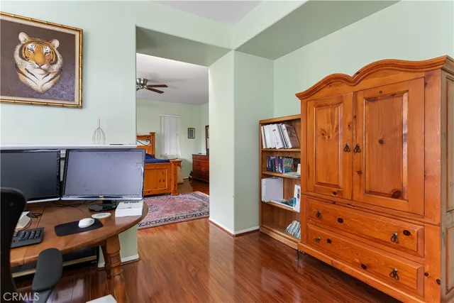a view of a workspace with furniture and wooden floor