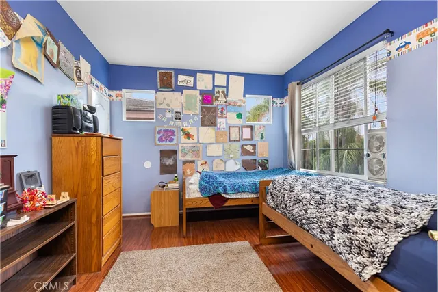 a bedroom with baby crib and large window