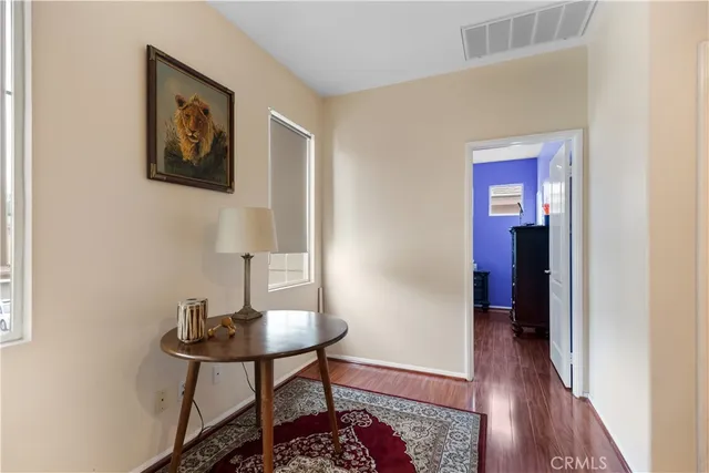 a view of a livingroom with a table and chairs