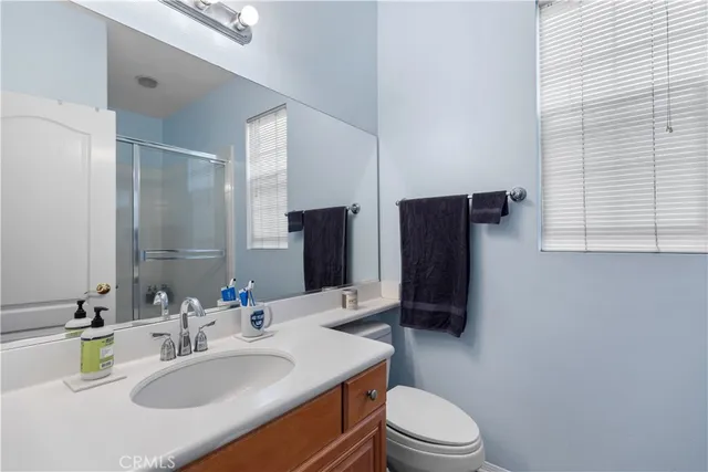a bathroom with a sink toilet and mirror