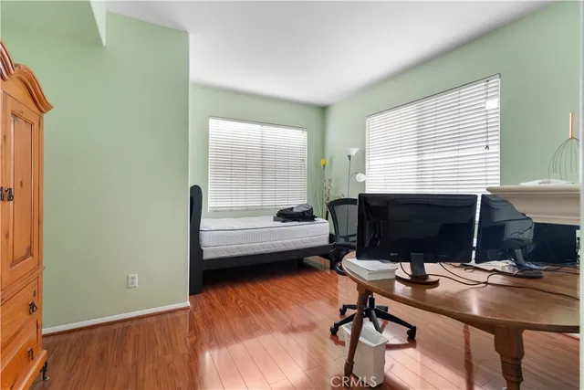 a view of a workspace with furniture and a window