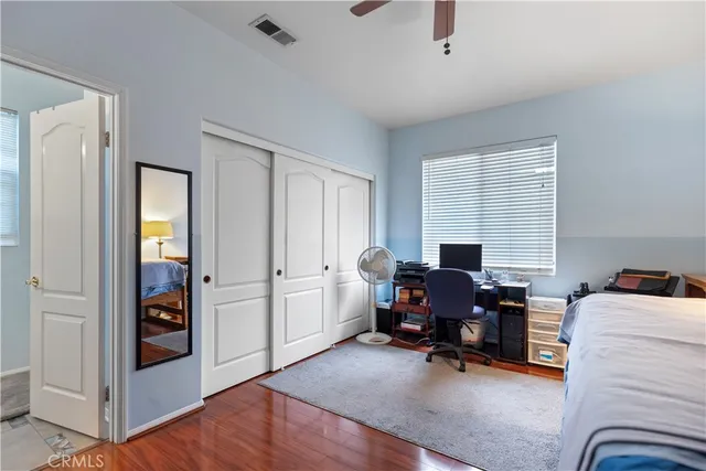 a view of a livingroom with workspace and a window