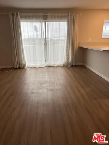 a kitchen with cabinets and wooden floor