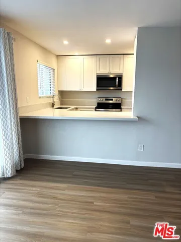a room with a cabinets and window